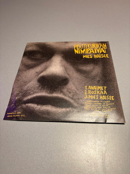 Pertti Kurikan Nimipäivät/Karanteeni: Mies Haisee/Joe Weider, 7inch, Special Pressing with the safety reflector, Multiply vinyl color versions, Light Blue, Punk & Pillu, Mauski Records, Finland 2015